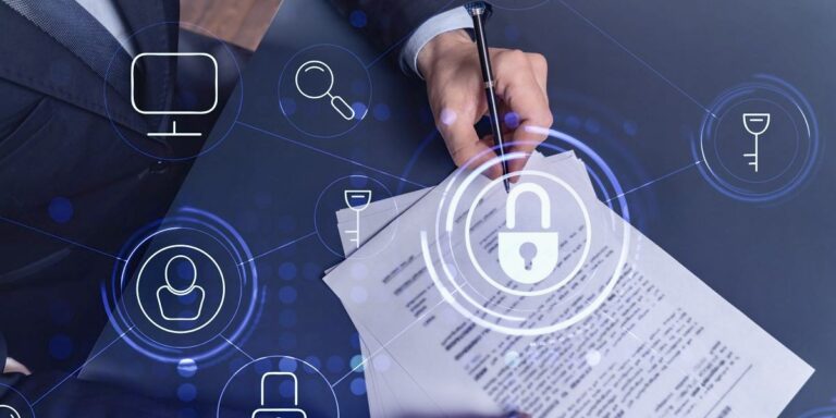 Person signing documents on a desk with digital cybersecurity icons, including a padlock and magnifying glass, superimposed over the image.