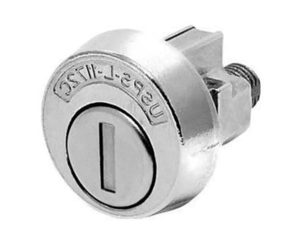 Close-up of a round metal cam lock with a slot for a key, featuring engraved markings on the surface—an essential piece of security hardware for locksmith products.